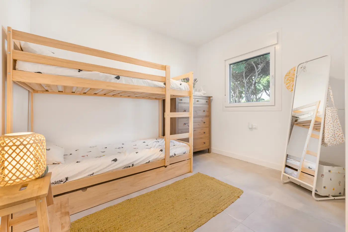 Children's room with bunk beds and a yellow rug