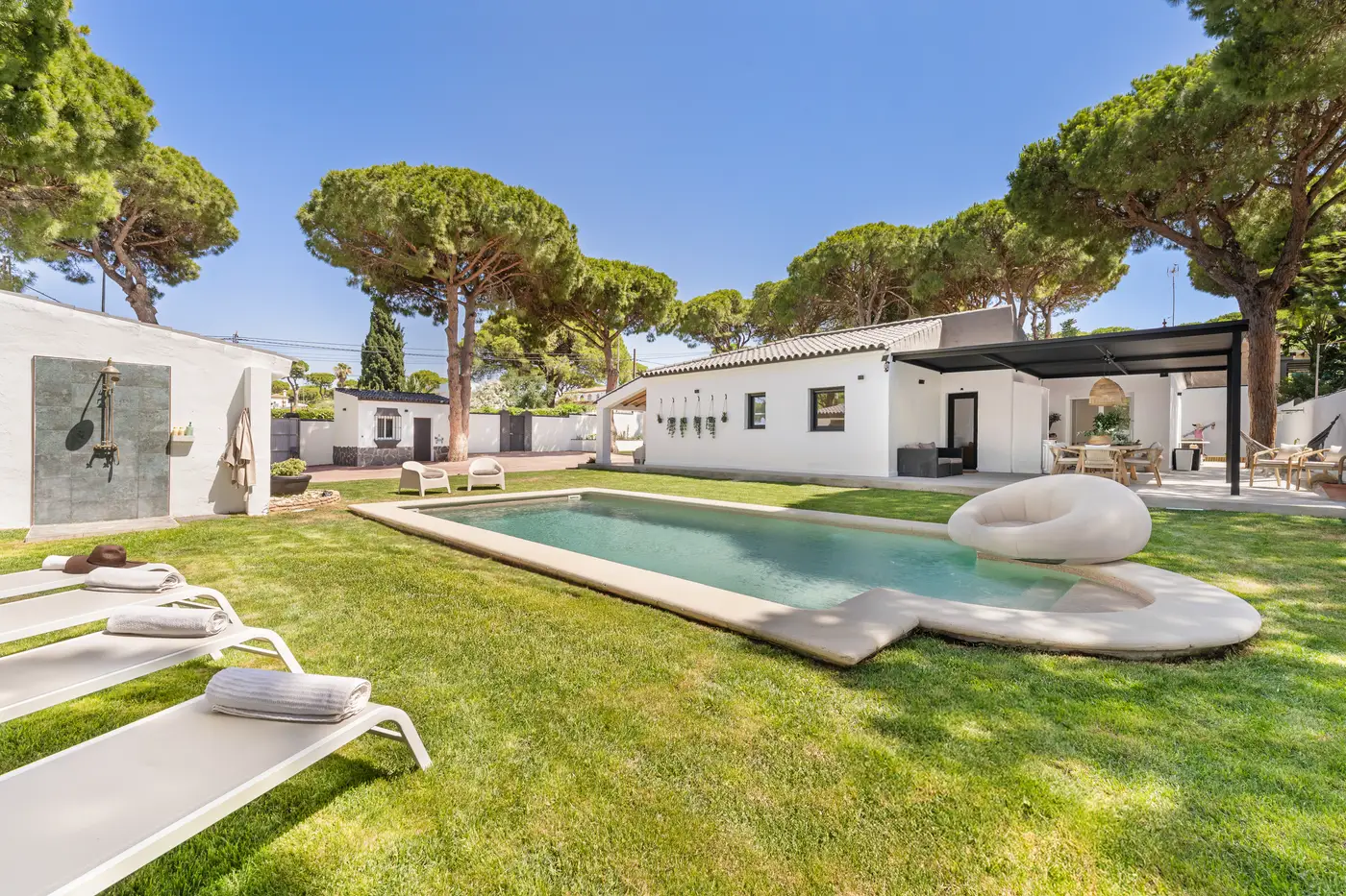 Saltwater pool with loungers on the lawn